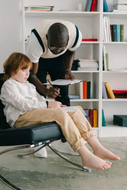 Clinician observing a child during an assessment